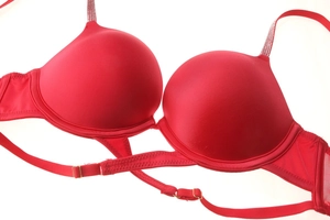 Detail of red push-up bra featuring rhinestone straps and smooth seamless cups finish
