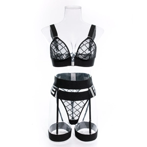 Detailed view of black mesh lingerie set with garter belt on mannequin against white background