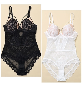 Detailed view of floral lace and polka dot mesh on black and white bodysuits