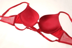 Detail view of red push-up bra featuring breathable mesh wings and adjustable straps
