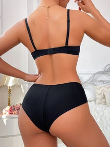 Rear view detail of black lace lingerie set with adjustable straps and hook closure