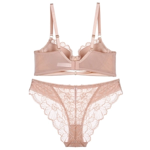 Detail of nude lace lingerie set showing embroidery texture and adjustable straps