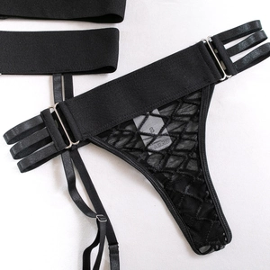 Detail view of black mesh lace panties and garter belt with adjustable metal buckles