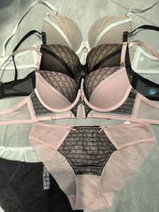 Detailed overhead shot of lace lingerie sets with polka dots and mesh in various colors