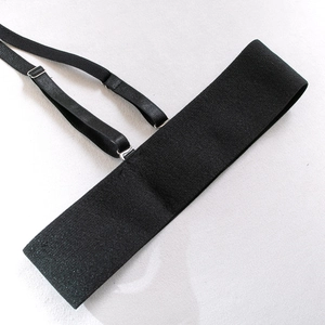 Detail of adjustable black elastic strap with metal sliders and textured knit surface