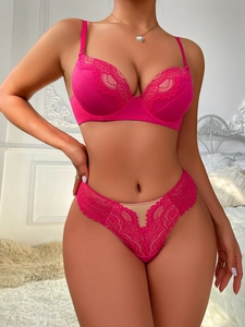 Detail of rose red lace lingerie set featuring eyelash lace trim and mesh paneling