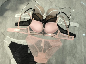 Detailed flat lay of lace lingerie sets in multiple colors with sheer polka dot mesh
