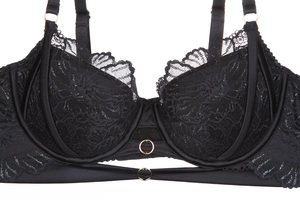 Detailed view of black floral lace bra featuring gold metal rings and adjustable straps