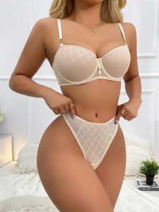 Detailed view of nude mesh lingerie set with diamond embroidery and gold ring accents