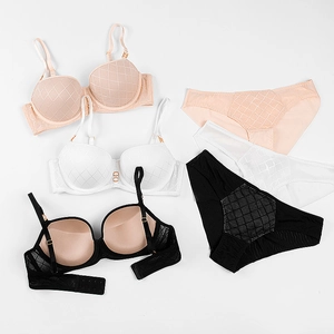 Macro detail of lingerie set with quilted texture pattern in black, white and pink