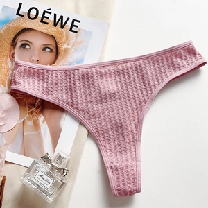 Close-up of pink waffle texture cotton thong on a white background with lifestyle props