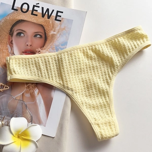 Detail of light yellow thong featuring breathable honeycomb textured fabric and smooth edges