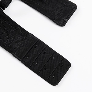 Detail of black lingerie back closure with three-row metal hook and eye fasteners