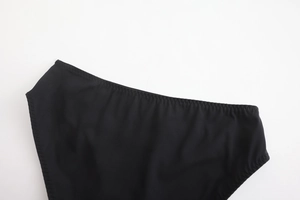 Macro detail of seamless black fabric with precise zigzag stitching for soft lingerie
