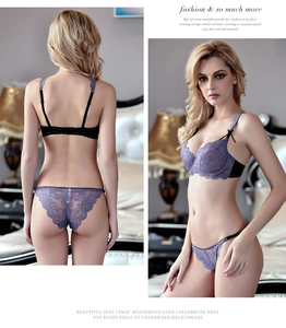 Detail of purple lace bra and matching panties with black straps and delicate bows