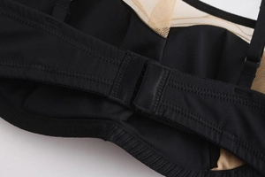 Detail of black seamless bra with mesh panel and secure double hook-and-eye back closure