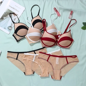 Flat lay of mesh bras and matching panties in black, white, and red color contrast sets