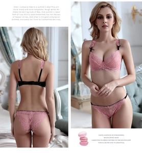 Close-up of pink floral lace bra with black ribbon bows and matching low-waist panties