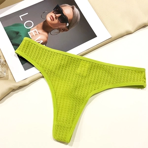 Detail of bright green high-cut panties featuring breathable waffle knit honeycomb texture