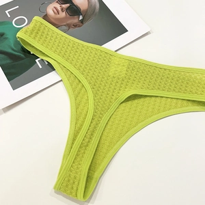 Detailed close-up of lime green honeycomb mesh thong with seamless binding details
