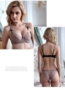 Close-up of sheer lace lingerie set with contrasting black straps and delicate bows