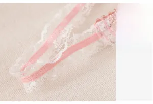 Detailed macro shot of light pink lace double shoulder straps with scalloped edges
