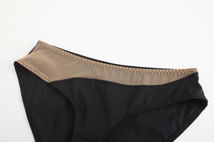 Detailed shot of seamless black panty with mesh splicing and zigzag stitching detail