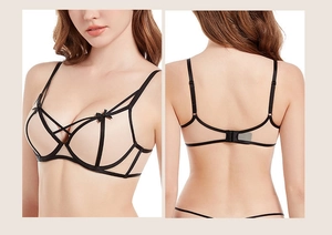 Detailed close-up of lace bra with cross-strap design and sheer mesh fabric details