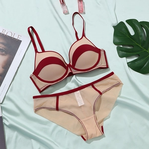 Flat lay of seamless mesh bra set with contrast burgundy piping and wave pattern