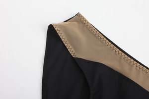 Macro shot of seamless black fabric with mesh拼接 and elegant zigzag stitching detail