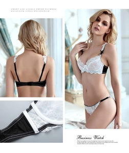 Detail of sheer lace bra with black and white contrast and delicate floral embroidery