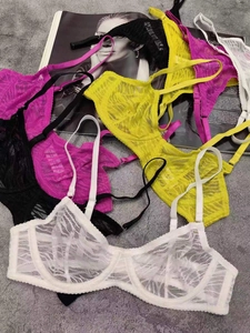 Detailed flat lay of ultra-thin lace bras in white, black, yellow and pink colors