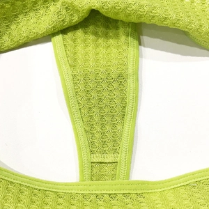 Macro detail of neon green waffle-knit cotton fabric with reinforced edge stitching