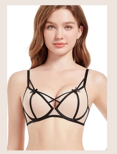 Detailed view of lace bra with elegant black cross straps and small bow decoration