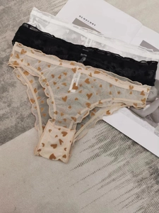 Three-pack mesh panties with delicate lace edges and heart print on a magazine layout
