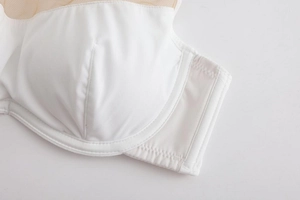 Detailed macro shot of white seamless bra featuring breathable mesh stitching and fine seams