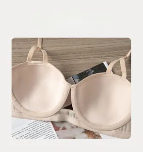 Close-up of seamless push-up bra in beige color with thin straps and mesh side wings