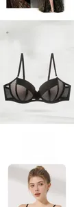 Detail of black lace bra showing mesh embroidery and widened side wings for support