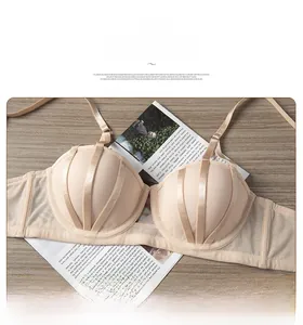 Detail view of beige push-up bra with satin striped cups and breathable mesh side wings
