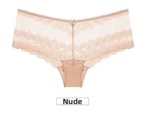 Detail of skin color lace panties with a small bow and breathable mesh texture