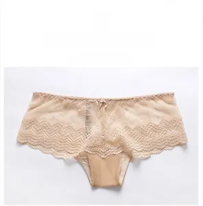 Close-up of beige floral lace underwear with bow detail and scalloped edges