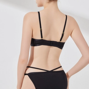Back view of black lace lingerie set with gold adjusters and cross strap panty design