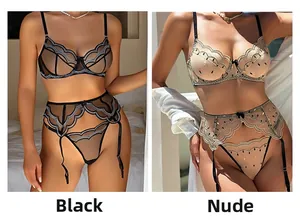 Detail view of lace embroidery on sheer mesh lingerie with adjustable garter belt set