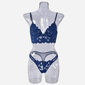 Detail of dark blue floral lace lingerie set showing embroidery texture and mesh fabric