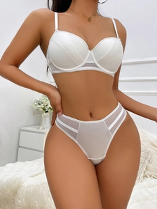 Detailed view of a white lace lingerie set with high waist thong and mesh side panels