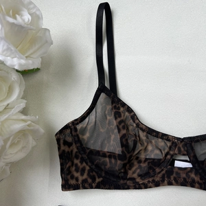 Detailed macro view of leopard print sheer mesh fabric and stitching on a bra