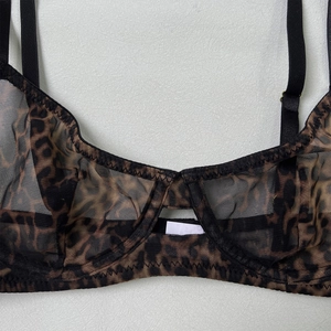 Detail of sheer leopard print mesh bra featuring adjustable black straps and soft cups