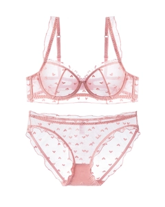 Detailed view of pink lace lingerie set featuring heart embroidery and ruffled edges