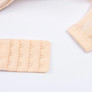 Detail view of the four-row three-hook back closure on the beige push-up bra set