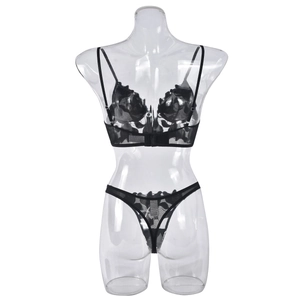 Detail of black floral lace lingerie set with sheer mesh and thin shoulder straps
